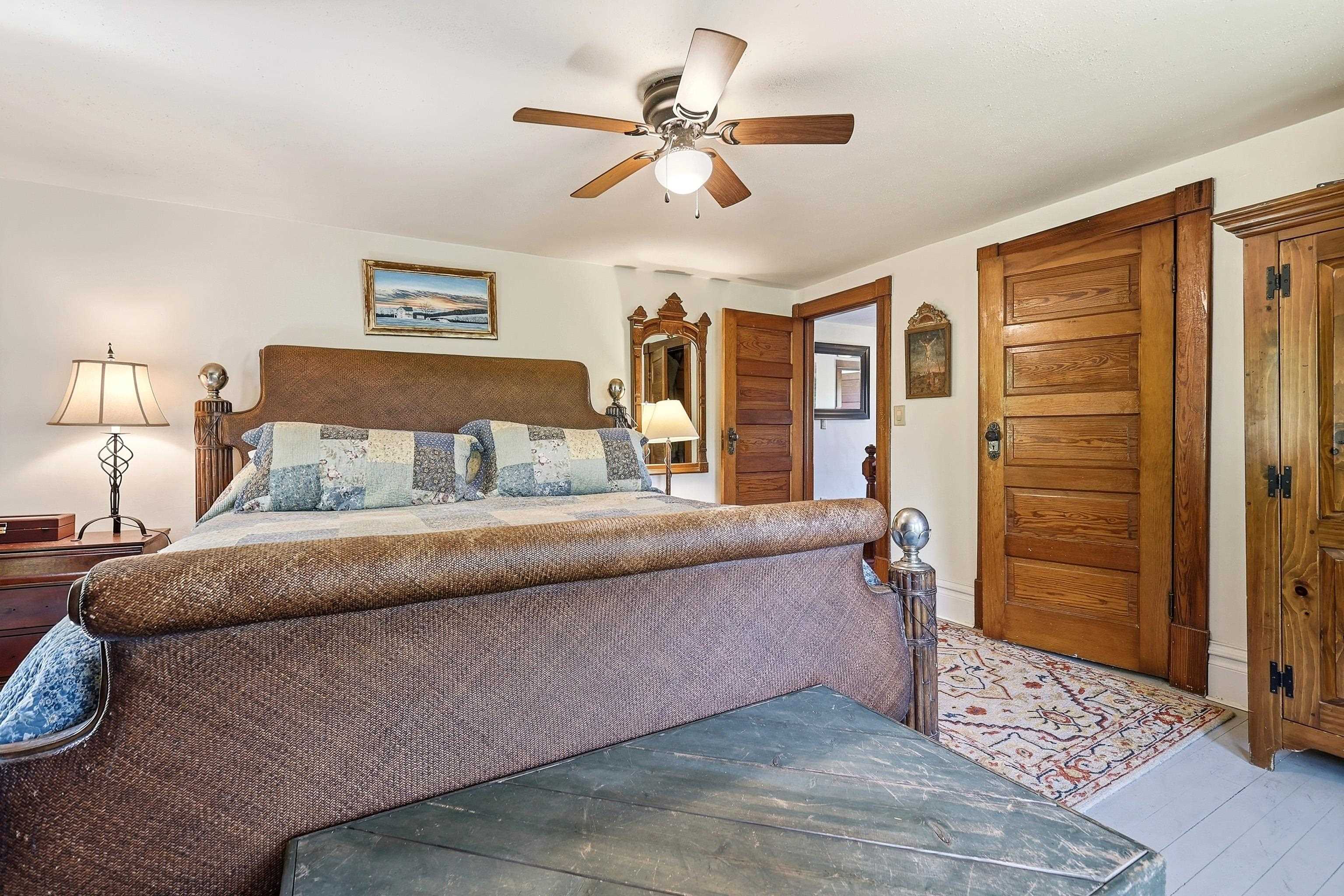 2181 South Irish Hollow Road Galena, IL 61036 - Photo 32 of 48 a bedroom with a large bed and a chandelier
