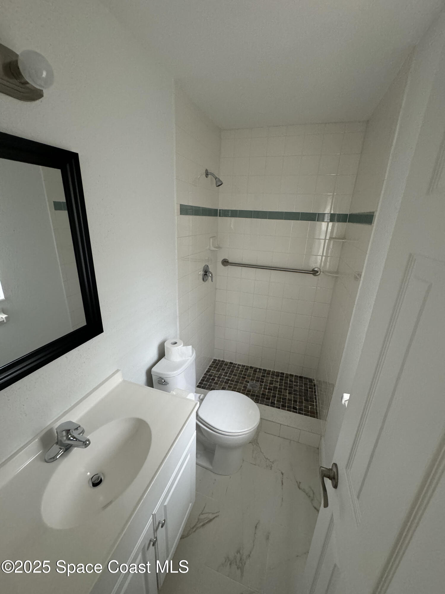 34 East Azalea Circle Rockledge, FL 32955 - Photo 9 of 11 a bathroom with a sink toilet and shower