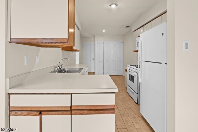 36 Needham Way, Unit D Princeton, NJ 08540 - Photo 11 of 30 a kitchen with a refrigerator sink and cabinets