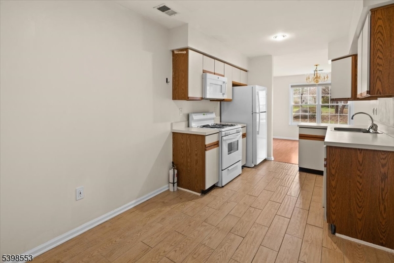 36 Needham Way, Unit D Princeton, NJ 08540 - Photo 12 of 30 a kitchen with stainless steel appliances granite countertop a sink stove and refrigerator