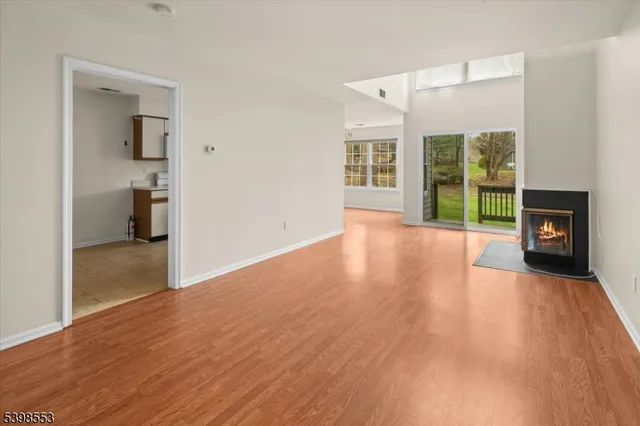 a view of a room with wooden floor and a fireplace