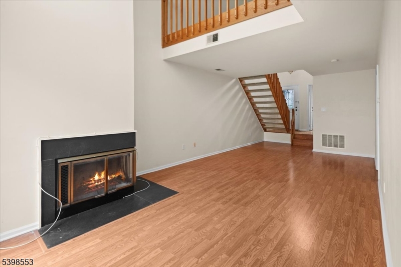 36 Needham Way, Unit D Princeton, NJ 08540 - Photo 9 of 30 a room with wooden floor and a fireplace