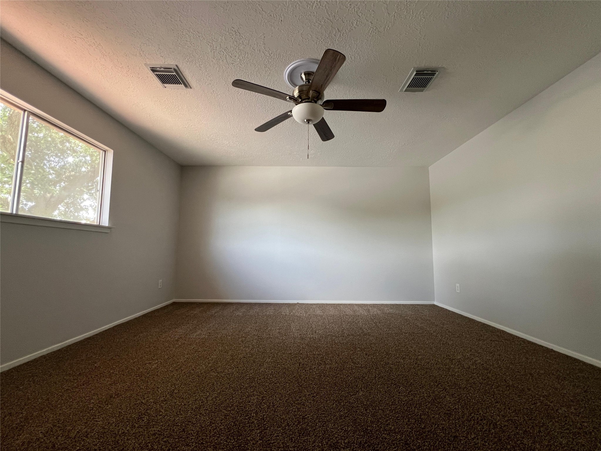 7012 Jetty Lane Houston, TX 77072 - Photo 14 of 24 an empty room with windows and fan
