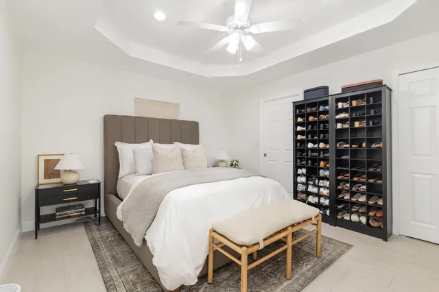 a bedroom with a bed and a chandelier