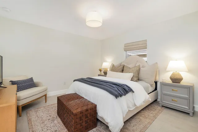 a bedroom with a bed and a lamp