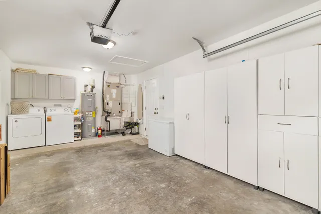 a view of a storage & utility room with two washing machine