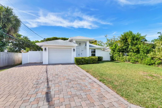 a front view of a house with a yard and a garage