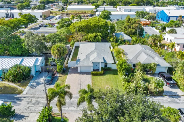 an aerial view of a house with a garden and lake view