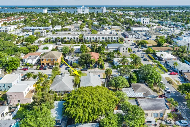 an aerial view of residential houses with outdoor space and trees