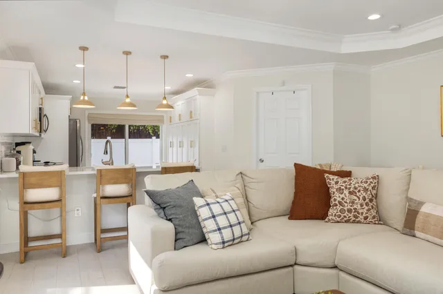 a living room with furniture and a chandelier
