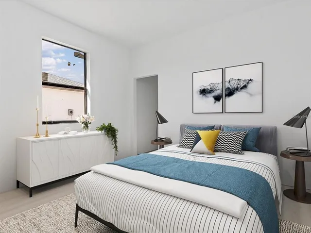 a bedroom with a bed and paintings on the wall