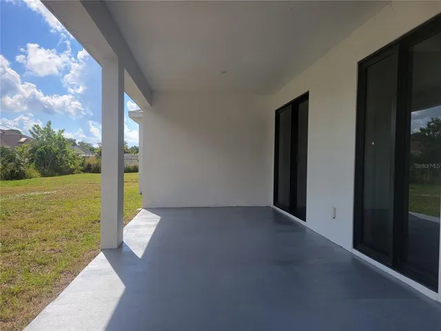 a view of a room with yard from a balcony