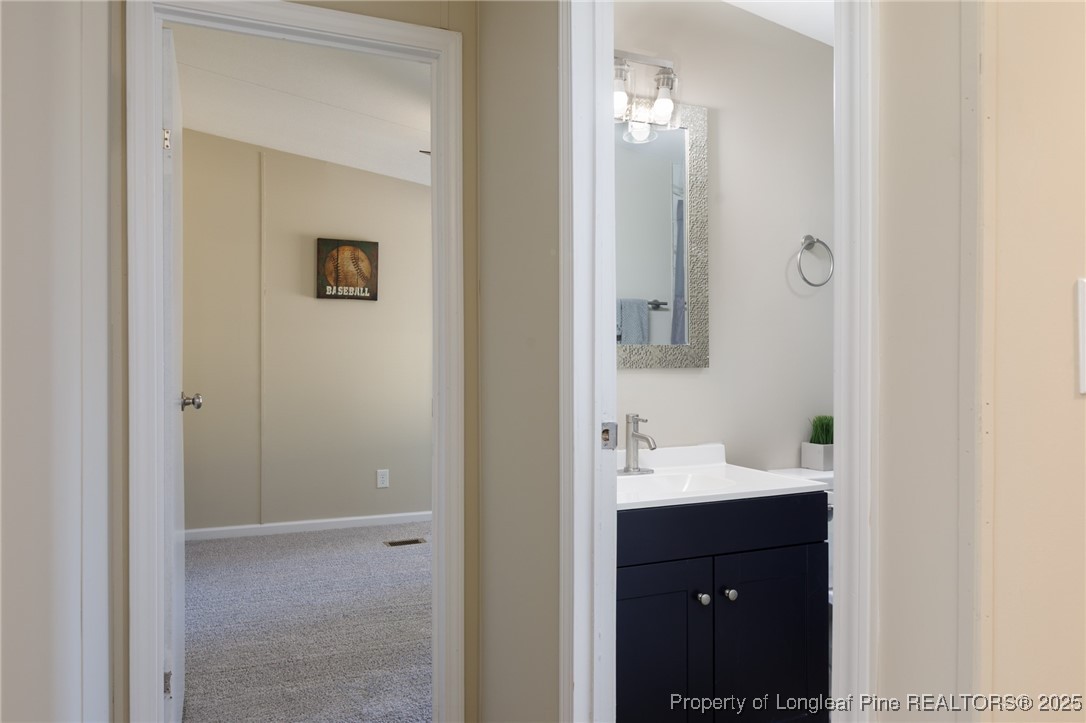 212 Heflin Road Aberdeen, NC 28315 - Photo 12 of 23 a bathroom with a sink and a mirror