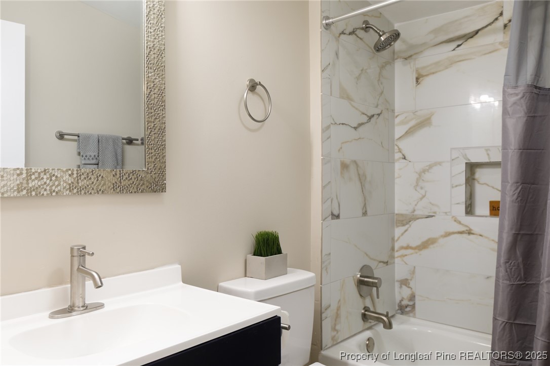 212 Heflin Road Aberdeen, NC 28315 - Photo 13 of 23 a bathroom with a sink and a mirror