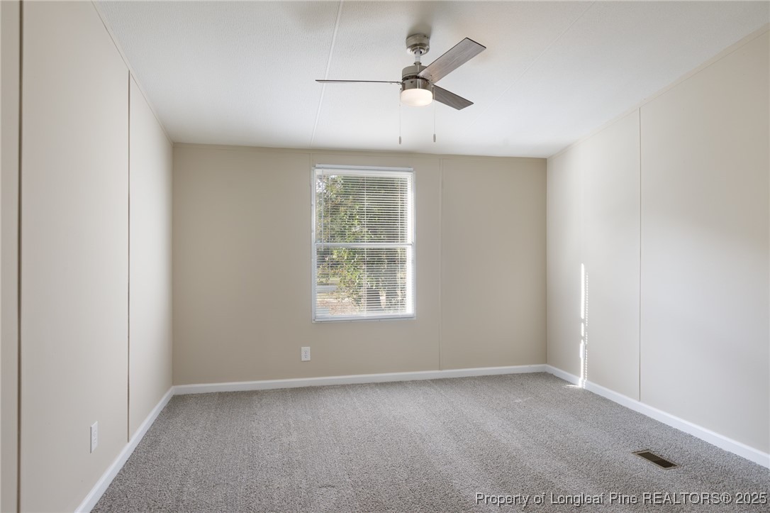 212 Heflin Road Aberdeen, NC 28315 - Photo 16 of 23 an empty room with a window and a fan