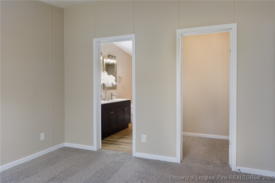 212 Heflin Road Aberdeen, NC 28315 - Photo 17 of 23 an empty room with mirror and a sink