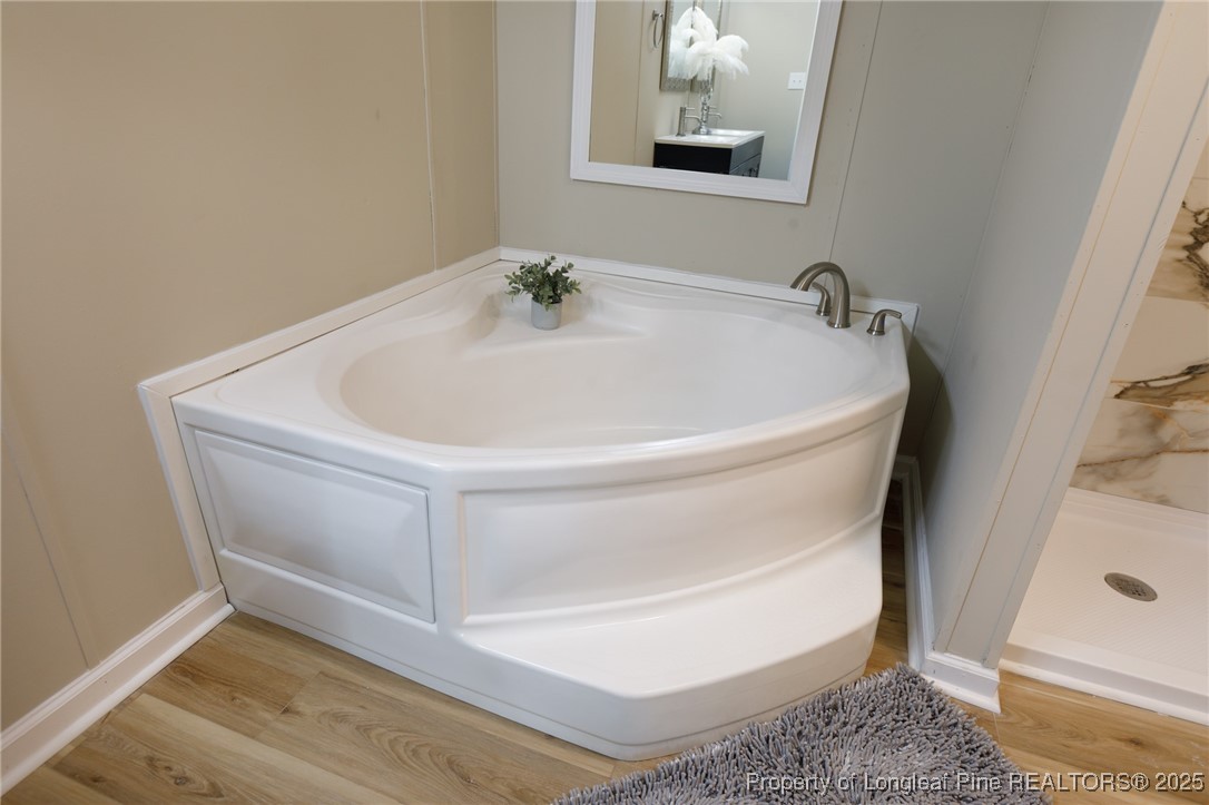 212 Heflin Road Aberdeen, NC 28315 - Photo 20 of 23 a white bath tub sitting in a bathroom