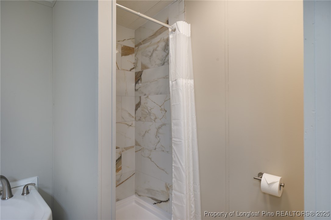212 Heflin Road Aberdeen, NC 28315 - Photo 21 of 23 a bathroom with a shower and toilet