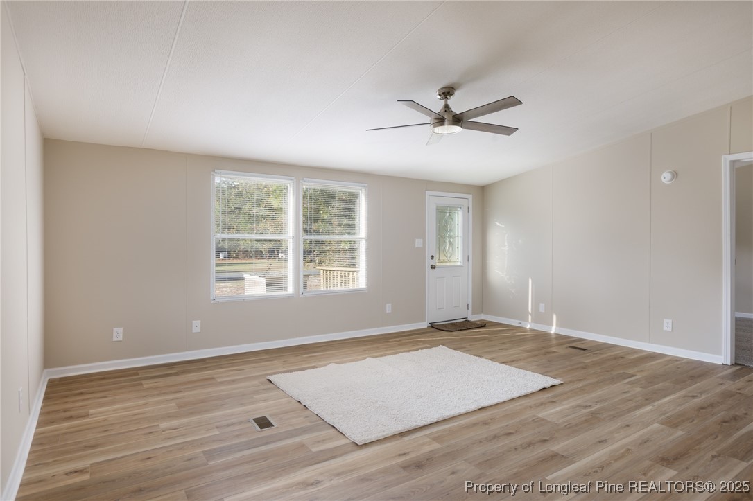 212 Heflin Road Aberdeen, NC 28315 - Photo 4 of 23 wooden floor in an empty room with a window