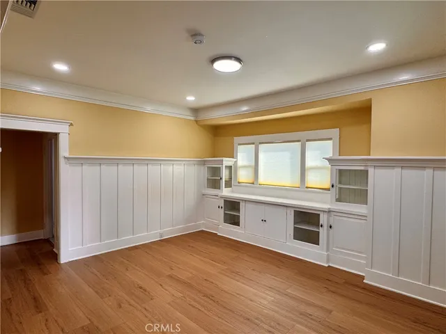 a view of kitchen with wooden floor and electronic appliances