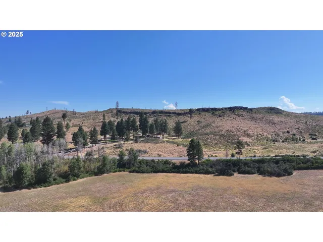a view of a lake with sunset in the background