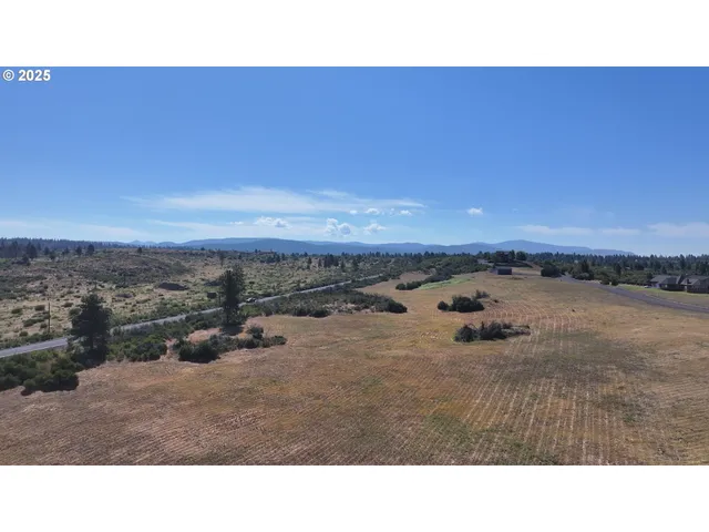 a open area with mountains in the background