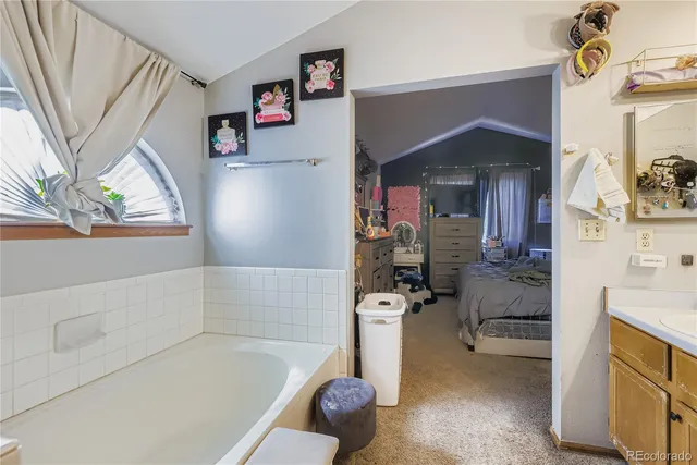 a bathroom with a granite countertop toilet sink and mirror