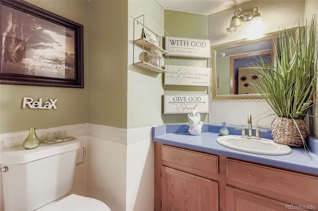 a bedroom with a bed dresser and flat screen tv