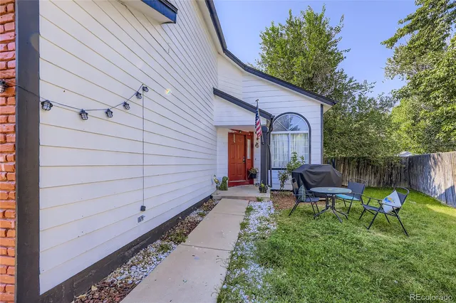 a car parked in front of a house with a yard