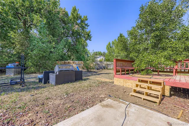 a view of a backyard with sitting area