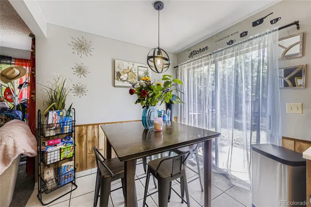 a view of a dining room with furniture and a potted plant