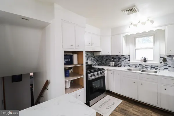 a kitchen with stainless steel appliances a refrigerator sink and stove