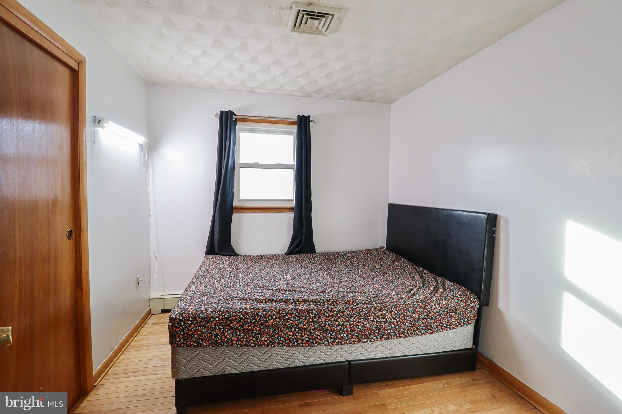 181 South Main Street Mount Wolf, PA 17347 - Photo 17 of 33 a bedroom with a large bed and wooden floor