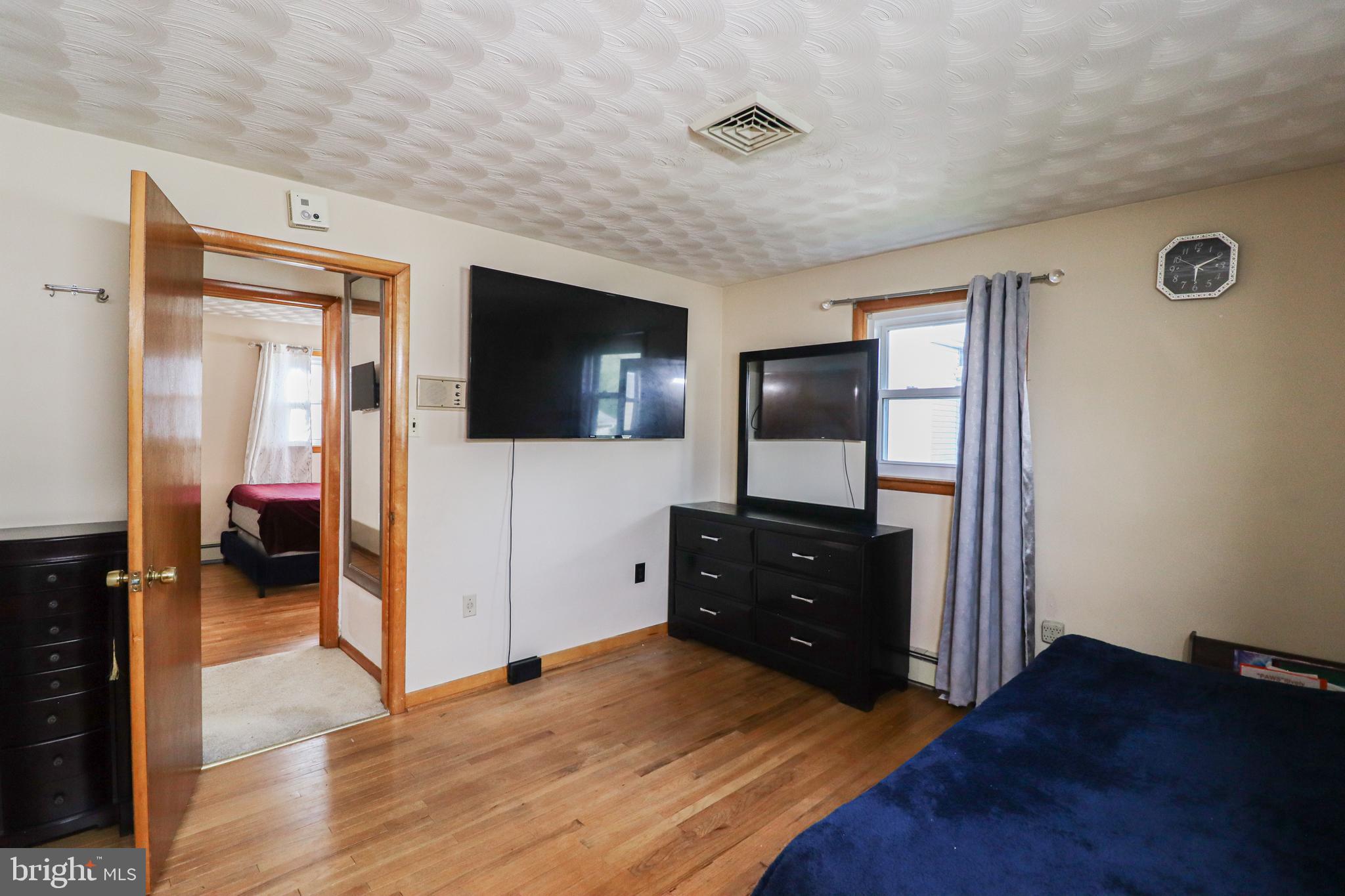 181 South Main Street Mount Wolf, PA 17347 - Photo 21 of 33 a living room with a dresser and a flat screen tv