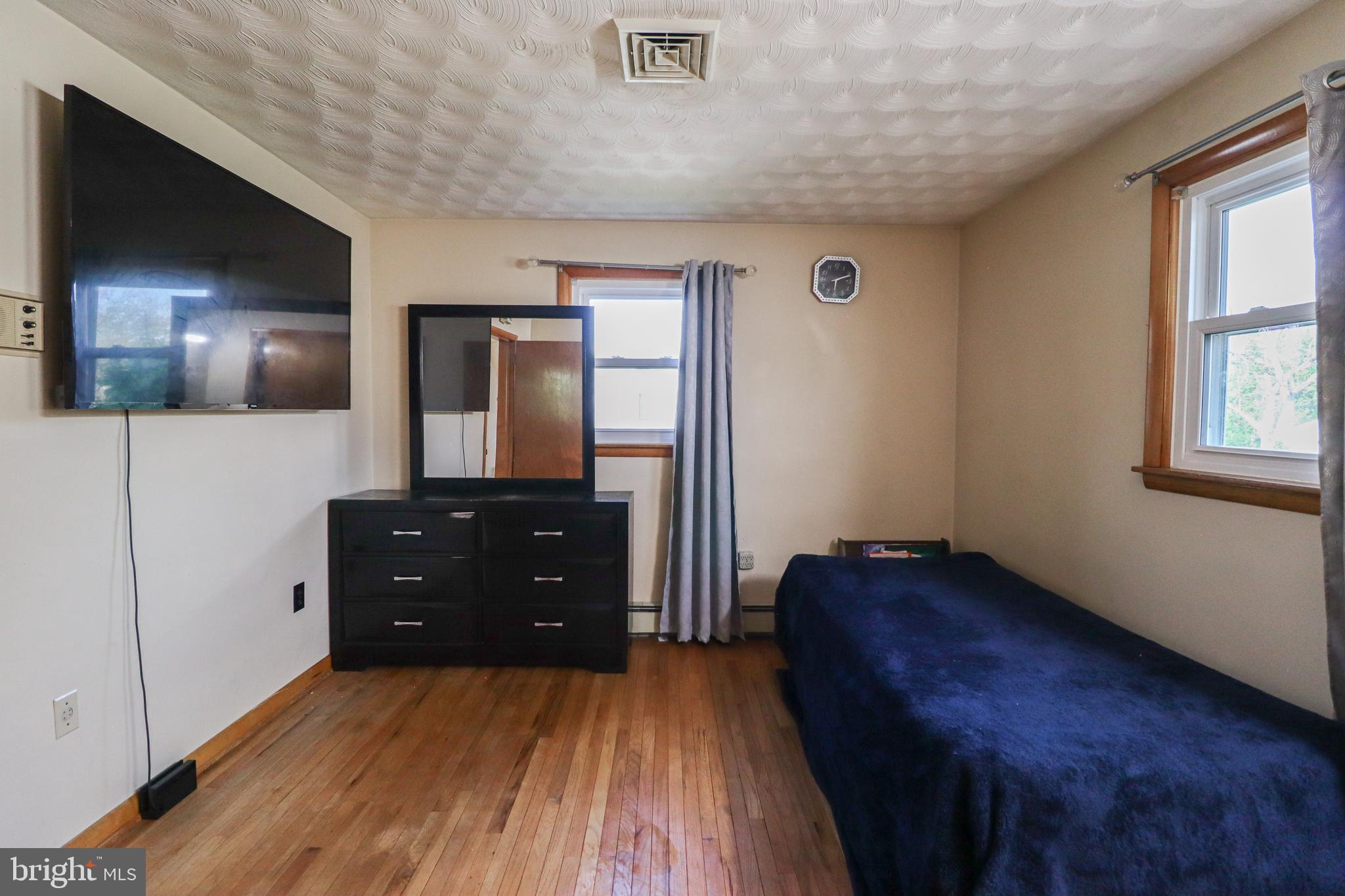 181 South Main Street Mount Wolf, PA 17347 - Photo 22 of 33 a bedroom with a bed and a flat tv screen on dresser