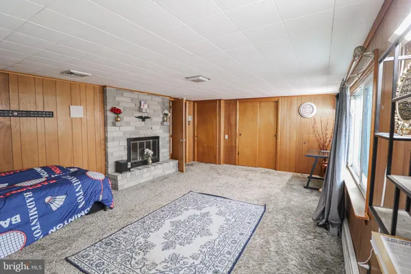 a bedroom with furniture and a fireplace