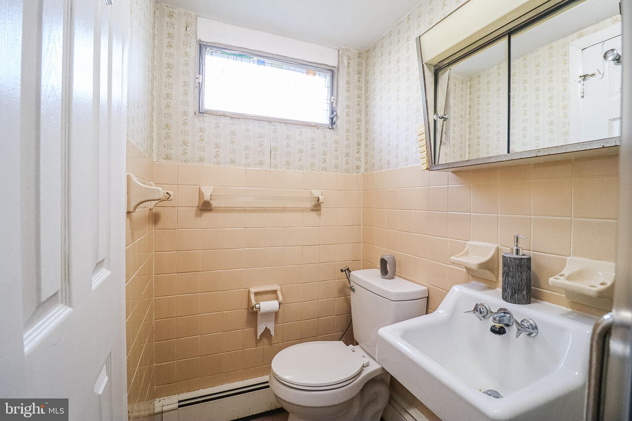 181 South Main Street Mount Wolf, PA 17347 - Photo 25 of 33 a bathroom with a sink a toilet and mirror