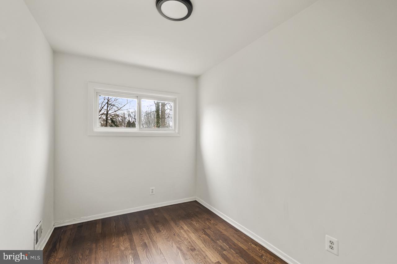 10725 Maple Street Fairfax, VA 22030 - Photo 28 of 42 a view of an empty room with wooden floor and a window