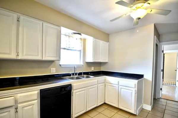 a kitchen with a stove a sink and a refrigerator