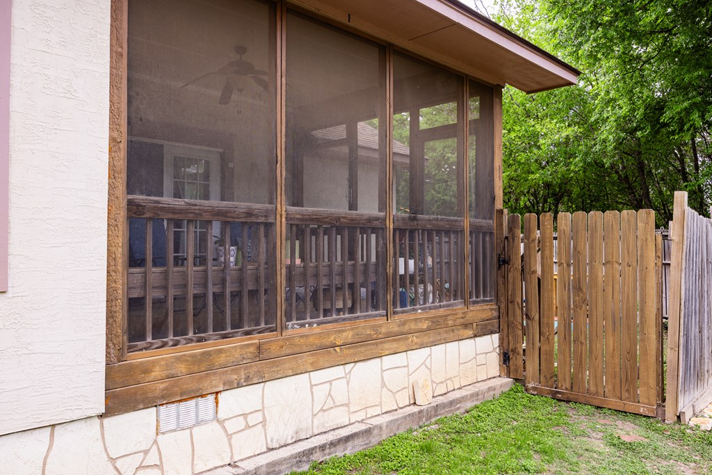 659 Town Creek Road Kerrville, TX 78028 - Photo 25 of 65 a view of backyard with large trees and wooden fence