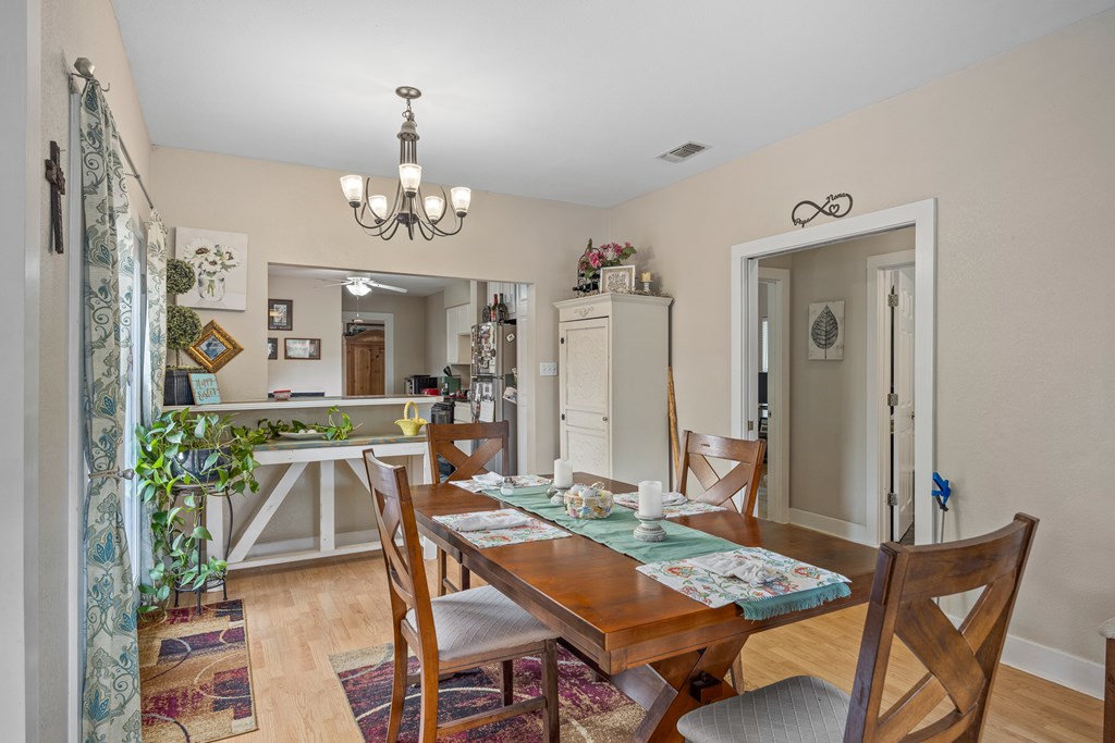 659 Town Creek Road Kerrville, TX 78028 - Photo 38 of 65 a view of a dining room with furniture and a chandelier