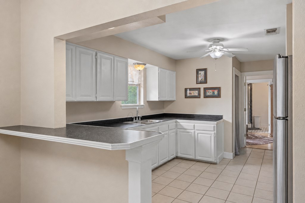 659 Town Creek Road Kerrville, TX 78028 - Photo 39 of 65 a kitchen with granite countertop a sink stainless steel appliances and cabinets
