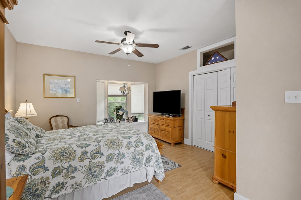 659 Town Creek Road Kerrville, TX 78028 - Photo 43 of 65 a bedroom with a bed and a flat screen tv