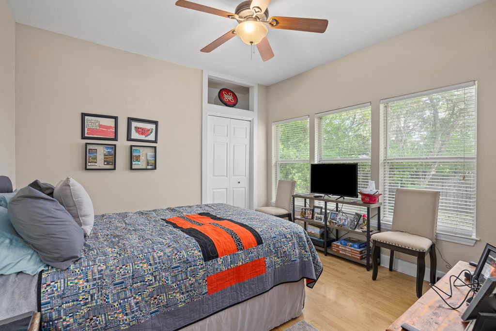 659 Town Creek Road Kerrville, TX 78028 - Photo 47 of 65 a bedroom with a bed and a flat screen tv