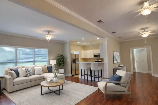 a living room with furniture and wooden floor