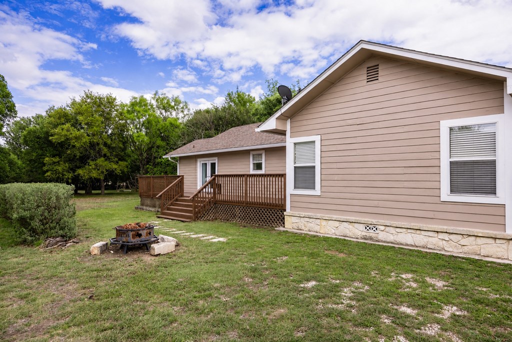 659 Town Creek Road Kerrville, TX 78028 - Photo 51 of 65 a view of a house with a backyard