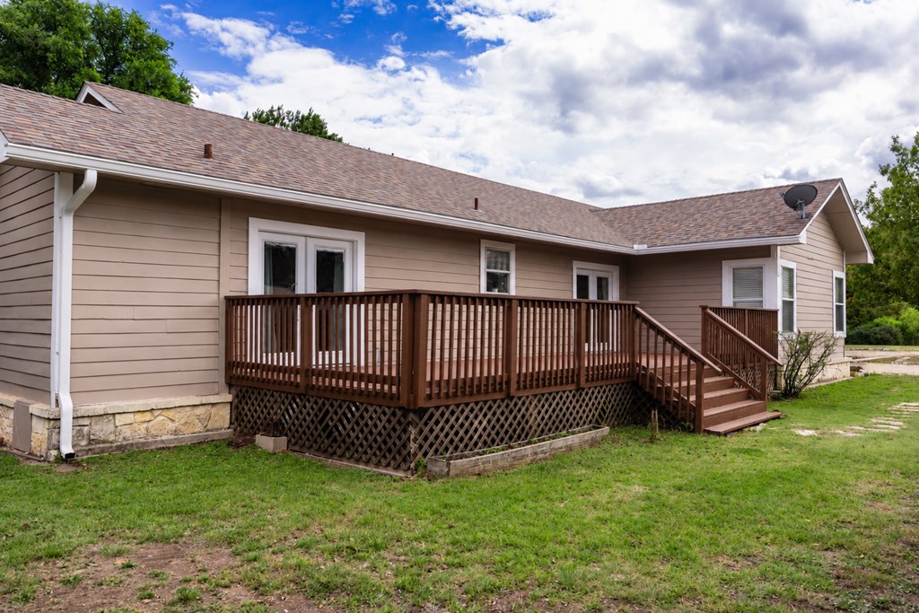 659 Town Creek Road Kerrville, TX 78028 - Photo 56 of 65 a view of a house with a backyard and deck