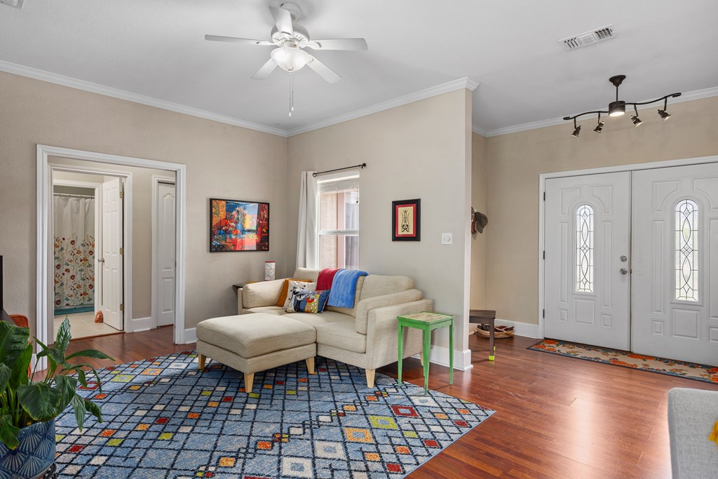 659 Town Creek Road Kerrville, TX 78028 - Photo 6 of 65 a living room with furniture a rug and a chandelier