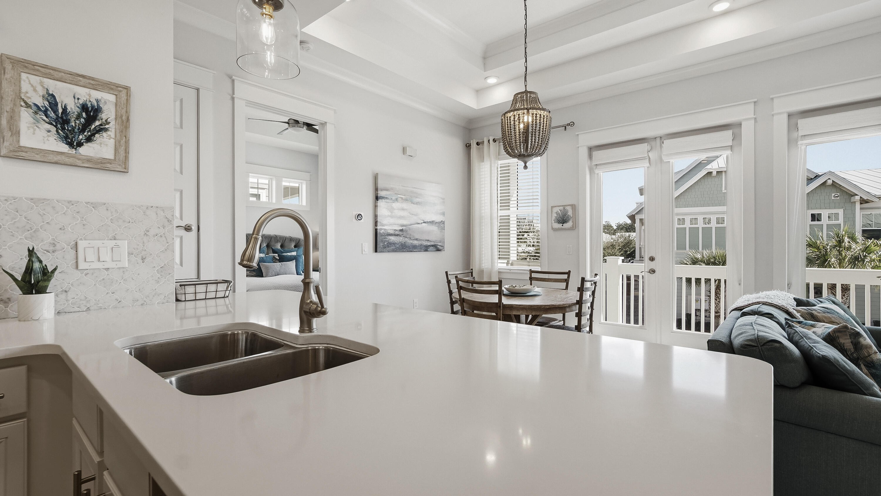 197 Milestone Drive, Unit C Inlet Beach, FL 32461 - Photo 18 of 72 a kitchen with stainless steel appliances a stove a sink a dining table and chairs with wooden floor