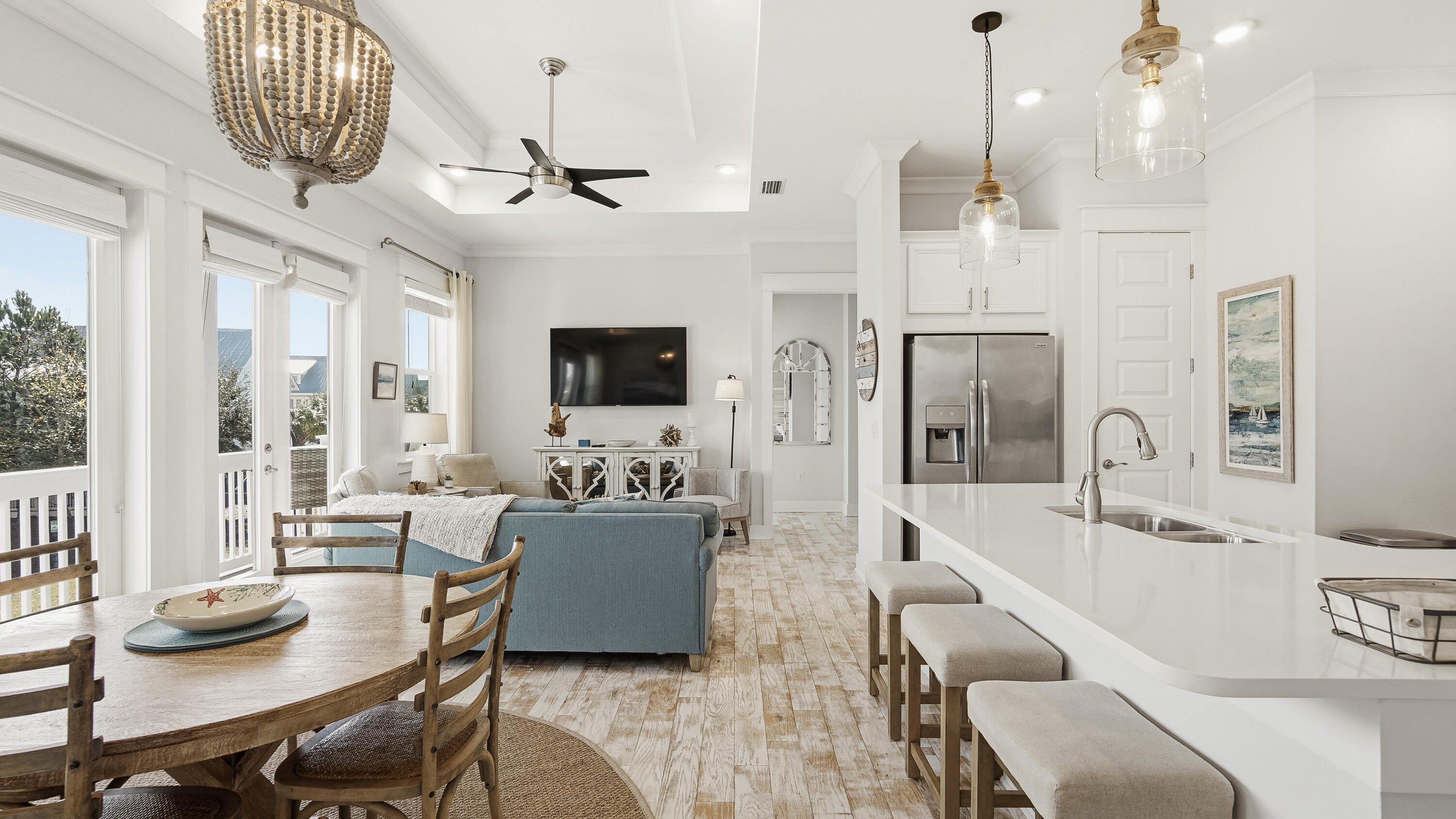 197 Milestone Drive, Unit C Inlet Beach, FL 32461 - Photo 2 of 72 a living room with furniture a flat screen tv and a chandelier